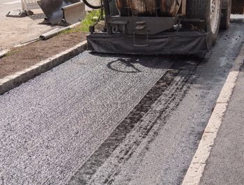 A Legacy Paving expert uses a machine to make an old road look brand new and smooth for safe and easy driving. A Legacy Paving expert uses a machine to make an old road look brand new and smooth for safe and easy driving.