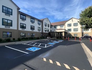 Legacy Paving shows a well-paved hotel entrance with smooth asphalt and marked parking, suggesting quality work for businesses. Legacy Paving shows a well-paved hotel entrance with smooth asphalt and marked parking, suggesting quality work for businesses.
